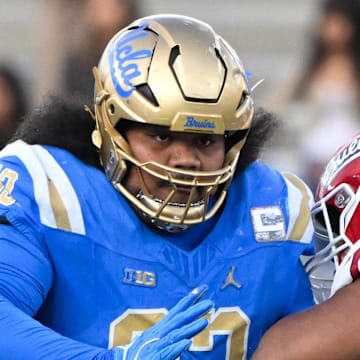 Nov 30, 2024; Pasadena, California, USA; UCLA Bruins defensive lineman Jay Toia (93) tangles with Fresno State Bulldogs offensive lineman Toreon Penright (77) during the fourth quarter at Rose Bowl. Mandatory Credit: Robert Hanashiro-Imagn Images
