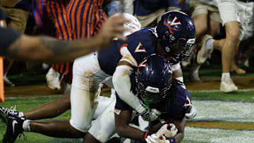Sep 26, 2025; Charlottesville, Virginia, USA; Virginia Cavaliers defensive back Ja'son Prevard (10) is hugged by Cavaliers defensive back Donavon Platt (28) as fans storm the field after making a game winning interception in the end zone against the Florida State Seminoles in the second overtime at Scott Stadium. Mandatory Credit: Geoff Burke-Imagn Images