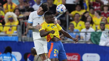 Jul 10, 2024; Charlotte, NC, USA;  Uruguay defender Jose Gimenez (2) and Columbia forward John Cordoba (24) go for a header during the first half at the Copa Armerica Semifinal match at Bank of America Stadium. Mandatory Credit: Jim Dedmon-USA TODAY Sports