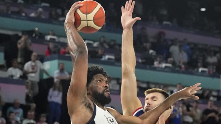 Aug 8, 2024; Paris, France; United States centre Joel Embiid (11) goes to the basket while defended by Serbia centre Filip Petrusev (3) during the first half in a men's basketball semifinal game during the Paris 2024 Olympic Summer Games at Accor Arena. Mandatory Credit: Rob Schumacher-USA TODAY Sports