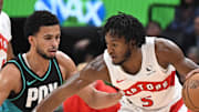 Toronto Raptors guard Immanuel Quickley dribbles the ball as Portland Trail Blazers forward Toumani Camara defends.
