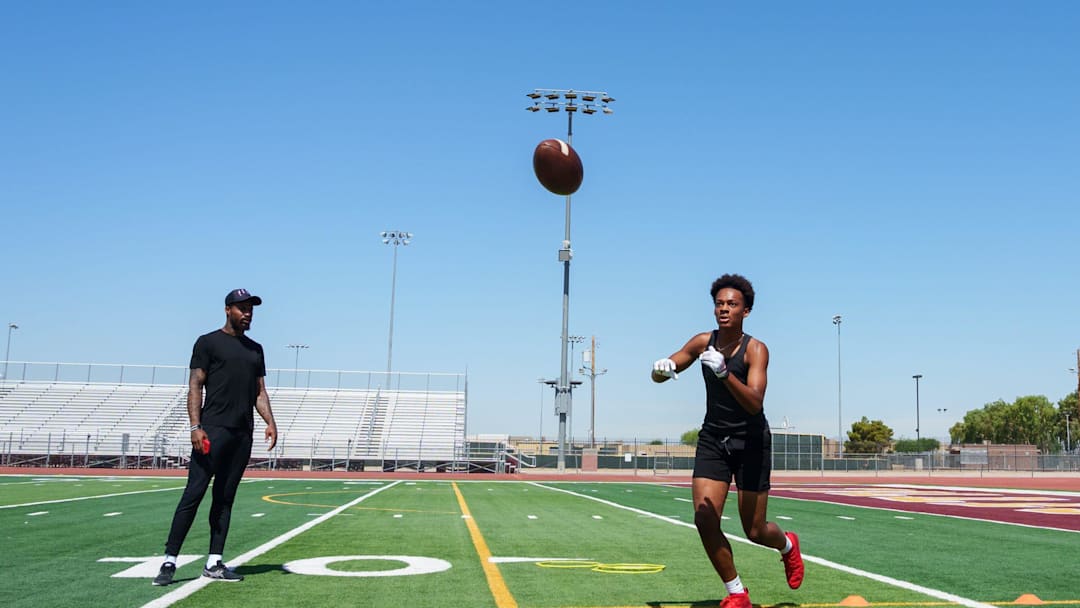 Former NFL wide receiver Jaelen Strong (left) watches Tolleson's Judah Lancaster during a private practice at Tolleson Union High School on June 16, 2023, in Tolleson.