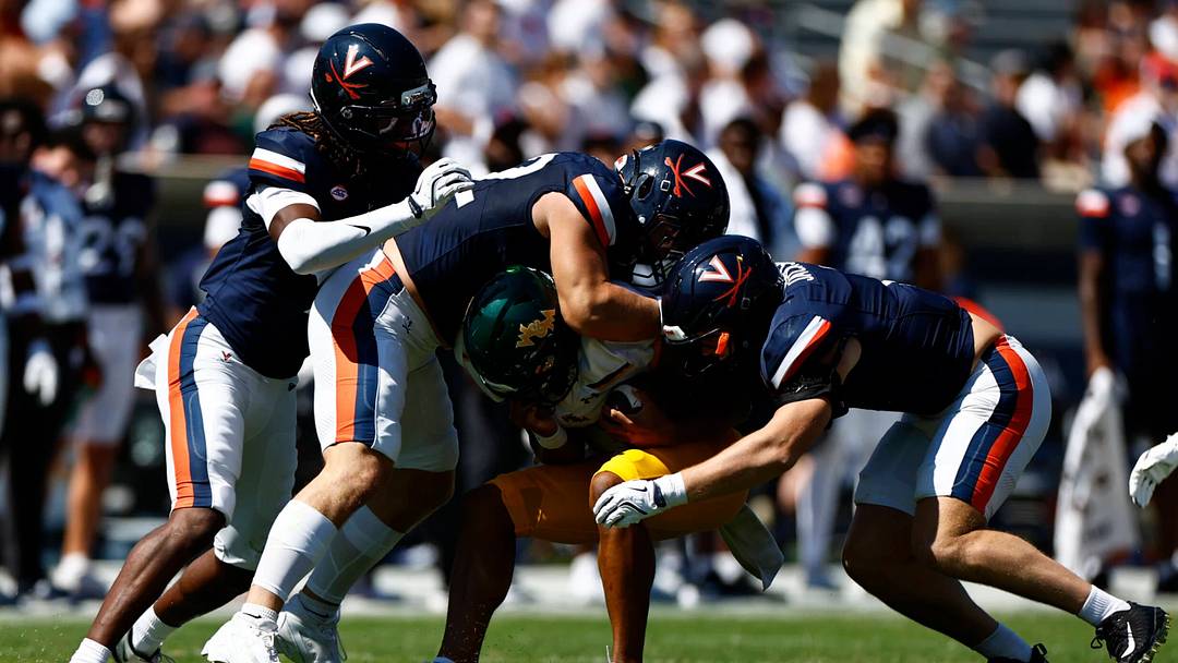 The Cavaliers swarm to tackle the Tribe ballcarrier in a 55-16 win over William & Mary, Sept. 13, 2025.