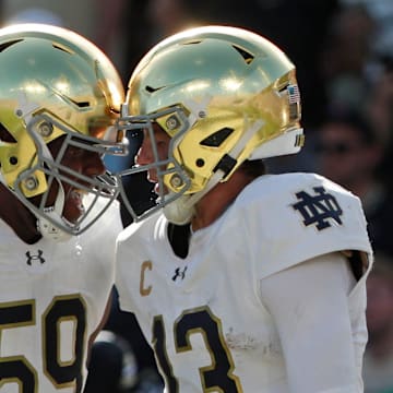 Notre Dame Fighting Irish quarterback Riley Leonard (13) celebrates with Notre Dame Fighting Irish offensive lineman Aamil Wagner (59) after scoring a touchdown Saturday, Sept. 14, 2024, during the NCAA football game against the Purdue Boilermakers at Ross-Ade Stadium in West Lafayette, Ind. Notre Dame Fighting Irish won 66-7.