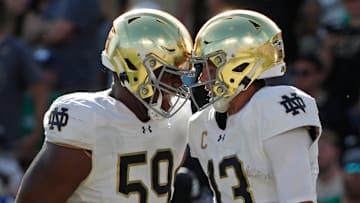 Notre Dame Fighting Irish quarterback Riley Leonard (13) celebrates with Notre Dame Fighting Irish offensive lineman Aamil Wagner (59) after scoring a touchdown Saturday, Sept. 14, 2024, during the NCAA football game against the Purdue Boilermakers at Ross-Ade Stadium in West Lafayette, Ind. Notre Dame Fighting Irish won 66-7.