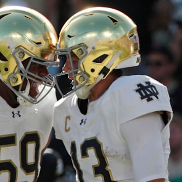 Notre Dame Fighting Irish quarterback Riley Leonard (13) celebrates with Notre Dame Fighting Irish offensive lineman Aamil Wagner (59) after scoring a touchdown Saturday, Sept. 14, 2024, during the NCAA football game against the Purdue Boilermakers at Ross-Ade Stadium in West Lafayette, Ind. Notre Dame Fighting Irish won 66-7.