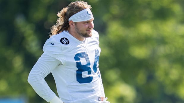 Colts tight end Tyler Warren (white and blue jersey) laughs at a training camp practice.