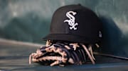 Chicago White Sox hat and glove in the dugout at Truist Park. 