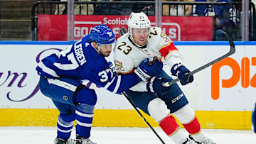Mar 27, 2022; Toronto, Ontario, CAN; Florida Panthers forward Carter Verhaeghe (23) tries to get around Toronto Maple Leafs defenseman Timothy Liljegren (37) at Scotiabank Arena. Mandatory Credit: John E. Sokolowski-Imagn Images
