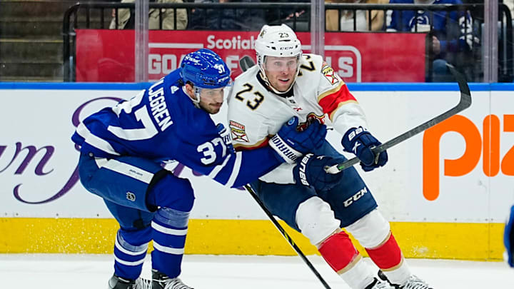 Mar 27, 2022; Toronto, Ontario, CAN; Florida Panthers forward Carter Verhaeghe (23) tries to get around Toronto Maple Leafs defenseman Timothy Liljegren (37) at Scotiabank Arena. Mandatory Credit: John E. Sokolowski-Imagn Images