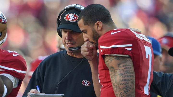 Jim Harbaugh talks to quarterback Colin Kaepernick at Levi's Stadium during a 2014 game. 