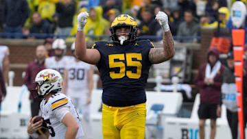 Michigan defensive lineman Mason Graham celebrates after sacking Minnesota quarterback Max Brosmer, in the background, during first-half action between Michigan and Minnesota at Michigan Stadium in Ann Arbor on Saturday, Sept. 28, 2024.