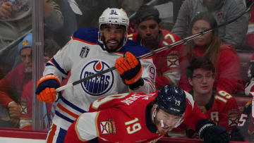 Florida Panthers forward Matthew Tkachuk (19) boards Edmonton Oilers forward Evander Kane (91)