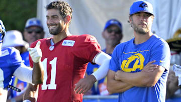  Los Angeles Rams quarterback Jimmy Garoppolo (11), quarterback Matthew Stafford (9), and quarterbacks coach Dave Ragone talks during training camp at Loyola Marymount University.