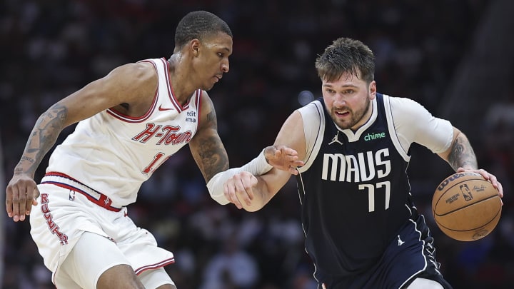 Mar 31, 2024; Houston, Texas, USA; Dallas Mavericks guard Luka Doncic (77) drives with the ball as Houston Rockets forward Jabari Smith Jr. (10) defends during the fourth quarter at Toyota Center. Mandatory Credit: Troy Taormina-USA TODAY Sports