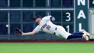 Jul 13, 2024; Houston, Texas, USA; Houston Astros left fielder Chas McCormick (20) dives to catch a fly ball for an out against the Texas Rangers during the fourth inning at Minute Maid Park. 