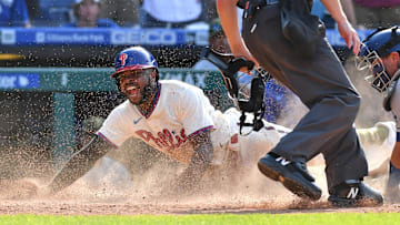 Philadelphia Phillies center fielder Roman Quinn slides safely into home with the winning run
