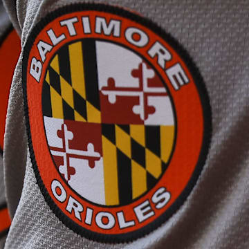 May 5, 2024; Cincinnati, Ohio, USA; The Baltimore Orioles logo on the sleeve of designated hitter Gunnar Henderson (2) as he prepares on deck during the seventh inning against the Cincinnati Reds at Great American Ball Park. 