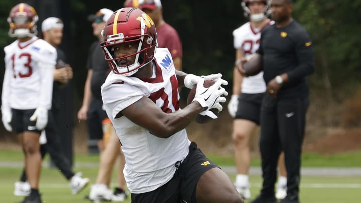 Jun 5, 2024; Ashburn, VA, USA; Washington Commanders wide receiver Davion Davis (84) catches the ball during OTA workouts at Commanders Park. Mandatory Credit: Geoff Burke-USA TODAY Sports