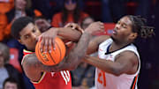 Jan 23, 2025; Champaign, Illinois, USA;  Maryland Terrapins forward Julian Reese (10) and Illinois Fighting Illini forward Morez Johnson Jr. (21) wrestle for a loose ball during the second half at State Farm Center. Mandatory Credit: Ron Johnson-Imagn Images
