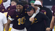 Arizona State Sun Devils head coach Kenny Dillingham is hugged on the sideline by defensive lineman Clayton Smith (10).