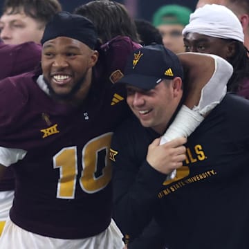 Arizona State Sun Devils head coach Kenny Dillingham is hugged on the sideline by defensive lineman Clayton Smith (10).