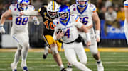 Nov 23, 2024; Laramie, Wyoming, USA; Boise State Broncos quarterback Maddux Madsen (4) runs against the Wyoming Cowboys during the third quarter at Jonah Field at War Memorial Stadium. Mandatory Credit: Troy Babbitt-Imagn Images

