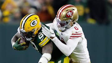 Green Bay Packers running back Josh Jacobs (8) gains a first down on a run against San Francisco 49ers cornerback Renardo Green (0) during their football game Sunday, November 24, 2024, at Lambeau Field in Green Bay, Wisconsin.