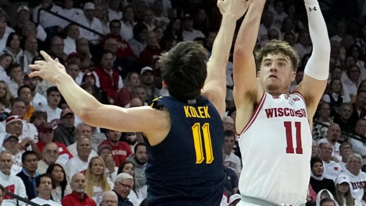 Dec 2, 2023; Madison, Wisconsin, USA; Wisconsin Badgers guard Max Klesmit (11) shoots over Marquette Golden Eagles guard Tyler Kolek (11) during the second half at the Kohl Center. Wisconsin won 75-64. Mandatory Credit: Mark Hoffman/Milwaukee Journal Sentinel via USA TODAY NETWORK
