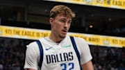 Oct 11, 2025; Dallas, Texas, USA; Dallas Mavericks forward Cooper Flagg (32) holds the basketball after a foul call in the second half of a game against the Charlotte Hornets at American Airlines Center. Mandatory Credit: Raymond Carlin III-Imagn Images