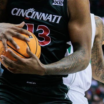 Mar 14, 2024; Kansas City, MO, USA; Cincinnati Bearcats forward Jamille Reynolds (13) rebounds the ball during the first half against the Baylor Bears at T-Mobile Center. Mandatory Credit: William Purnell-Imagn Images