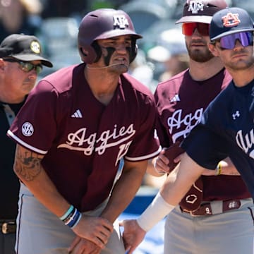Auburn Tigers' Cooper McMurray (26) encourages Texas A&M Aggies' Jace LaViolette (17) after LaViolette got hit in the hands by a pitch as Auburn Tigers take on Texas A&M Aggies during the SEC baseball tournament at Hoover Met in Birmingham, Ala., on Thursday, May 22, 2025.