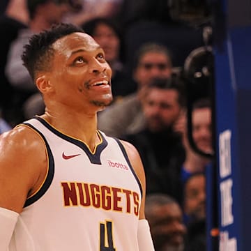 Mar 17, 2025; San Francisco, California, USA;  Denver Nuggets guard Russell Westbrook (4) smiles ahead of a sign reading “Russ” after a play against the Golden State Warriors during the fourth quarter at Chase Center. Mandatory Credit: Kelley L Cox-Imagn Images