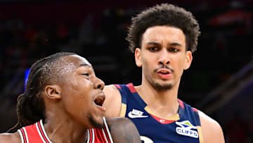 Chicago Bulls guard Ayo Dosunmu drives to the basket against Cleveland Cavaliers guard Tyrese Proctor.