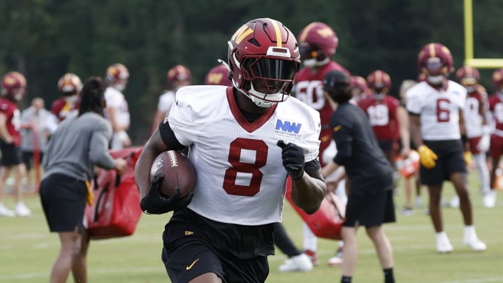 Jul 25, 2024; Ashburn, VA, USA; Washington Commanders running back Brian Robinson Jr. (8) carries a ball during drills on day two of Commanders training camp at OrthoVirginia Training Center at Commanders Park. Mandatory Credit: Geoff Burke-USA TODAY Sports