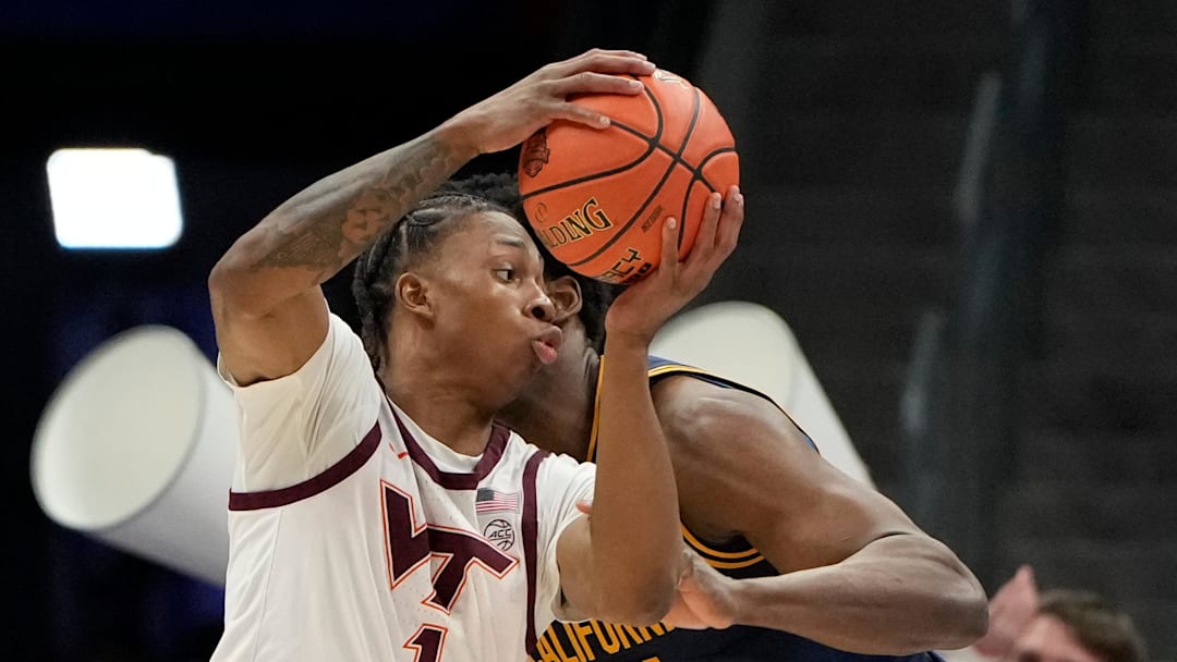 Mar 11, 2025; Charlotte, NC; Virginia Tech forward Tobi Lawal (1) with the ball as California Golden Bears forward Lee Dort (34) defends.