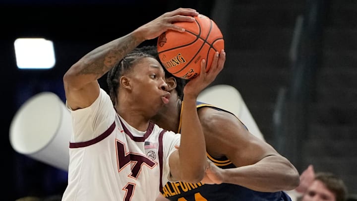 Virginia Tech Hokies forward Tobi Lawal with the ball as California Golden Bears forward Lee Dort. Virginia Tech Hokies forward Tobi Lawal with the ball as California Golden Bears forward Lee Dort.