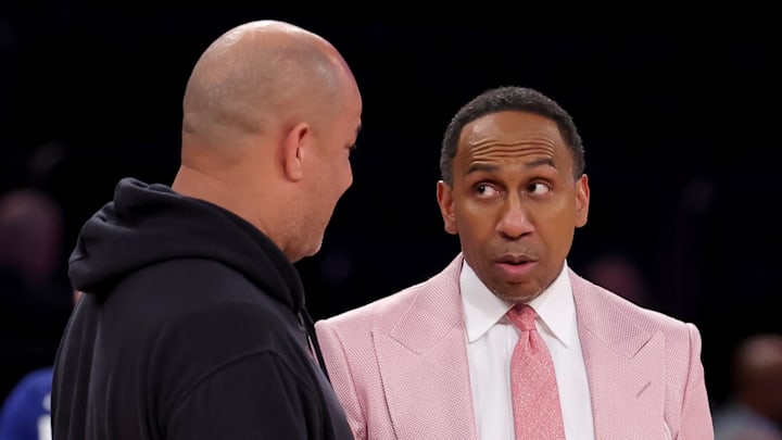ESPN personality Stephen A. Smith talks to New York Knicks assistant coach Rick Brunson in the 2025 NBA Playoffs