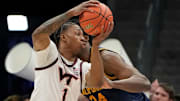 Mar 11, 2025; Charlotte, NC; Virginia Tech forward Tobi Lawal (1) with the ball as Cal forward Lee Dort (34) defends.