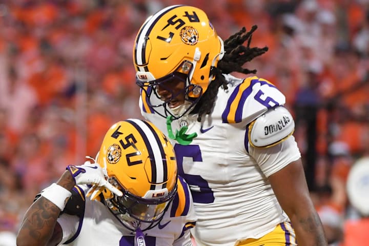 LSU Tigers cornerback PJ Woodland celebrates with LSU Tigers defensive end Patrick Payton. 