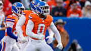 Jan 5, 2025; Denver, Colorado, USA; Denver Broncos linebacker Jonathon Cooper (0) reacts ahead of teammates after a sack in the second quarter against the Kansas City Chiefs at Empower Field at Mile High. 