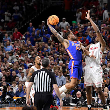 Florida's Alijah Martin (15) flies to the basket while Houston's Joseph Tugler tries to block.
