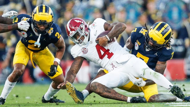 Alabama quarterback Jalen Milroe (4) runs against Michigan defensive back Makari Paige (7) during the second half of the Rose Bowl in Pasadena, Calif., on Monday, Jan. 1, 2024.