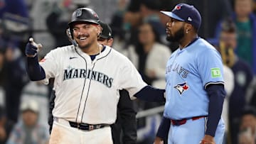 Oct 16, 2025; Seattle, Washington, USA; Seattle Mariners first baseman Josh Naylor (12) reacts in front of Toronto Blue Jays first baseman Vladimir Guerrero Jr. (27) after singling in the ninth inning during game four of the ALCS round for the 2025 MLB playoffs at T-Mobile Park. Mandatory Credit: Kevin Ng-Imagn Images