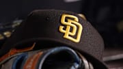 Jul 23, 2021; Miami, Florida, USA; A general view of a San Diego Padres hat and glove in the dugout prior to the game between the Miami Marlins and the San Diego Padres at loanDepot park. 