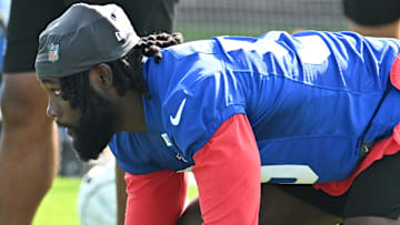 Former Houston Texans defensive end Kingsley Jonathan (59) runs a drill during a training camp session at St. John Fisher University.