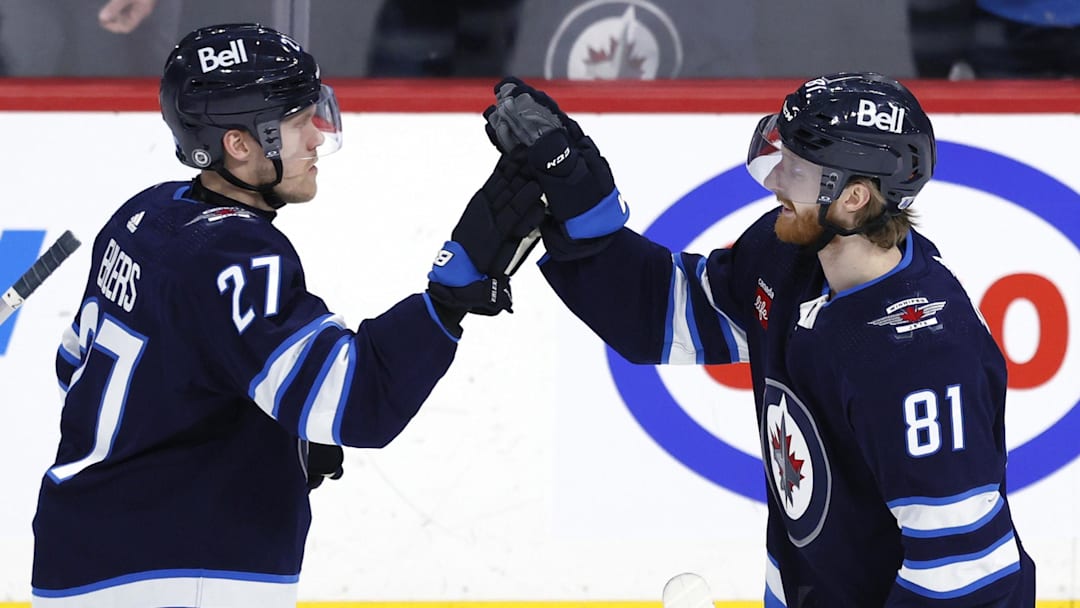 Feb 25, 2024; Winnipeg, Manitoba, CAN; \Winnipeg Jets left wing Kyle Connor (81) celebrates his overtime goal with Winnipeg Jets left wing Nikolaj Ehlers (27) against the Arizona Coyotes at Canada Life Centre. Mandatory Credit: James Carey Lauder-Imagn Images
