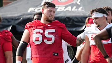 Aug 1, 2024; Columbus, OH, USA; Ohio State Buckeyes offensive lineman Zen Michalski (65) warms up during football camp at the Woody Hayes Athletic Complex.