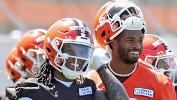 Cleveland Browns running back Quinshon Judkins (10) and quarterback Shedeur Sanders (12) share a laugh on the sideline during NFL rookie minicamp at the Cleveland Browns training facility on Friday, May 9, 2025, in Berea, Ohio.