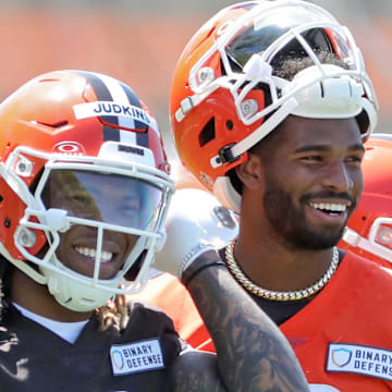 Cleveland Browns running back Quinshon Judkins (10) and quarterback Shedeur Sanders (12) share a laugh on the sideline during NFL rookie minicamp at the Cleveland Browns training facility on Friday, May 9, 2025, in Berea, Ohio.